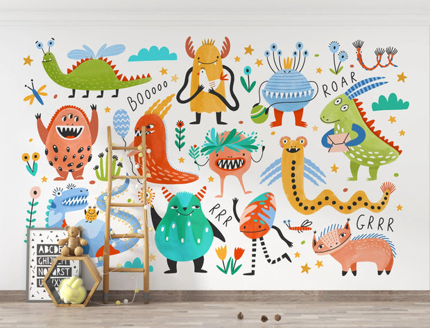 Colorful children's wall mural with cartoon monsters and animals on a white wall.