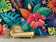 Colorful tropical leaf and flower patterned wall with a yellow sofa and small table.