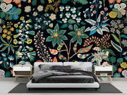 Bedroom with colorful floral wallpaper and modern furniture.