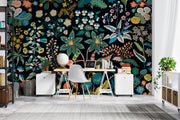 Colorful floral wallpaper in a home office setting with a desk and chair.