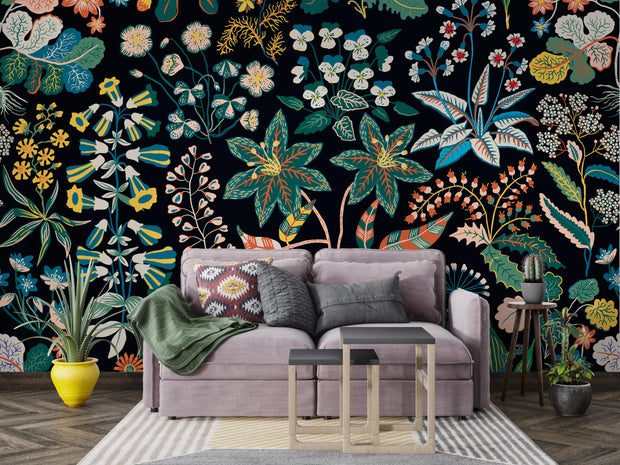 Living room with a gray sofa against a vibrant floral wall mural.