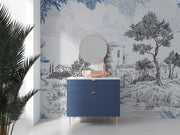 Blue dresser with round mirror against a decorative wallpapered wall