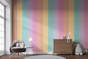 Living room with a colorful striped wall, gray armchair, wooden cabinet, and decorative items.