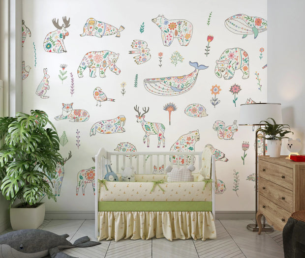 Nursery room with floral animal wall decals on a white wall.