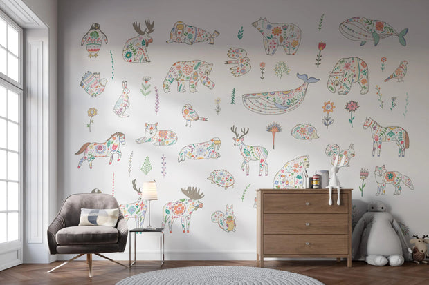 Children's room with floral animal wall decals on a light gray wall.