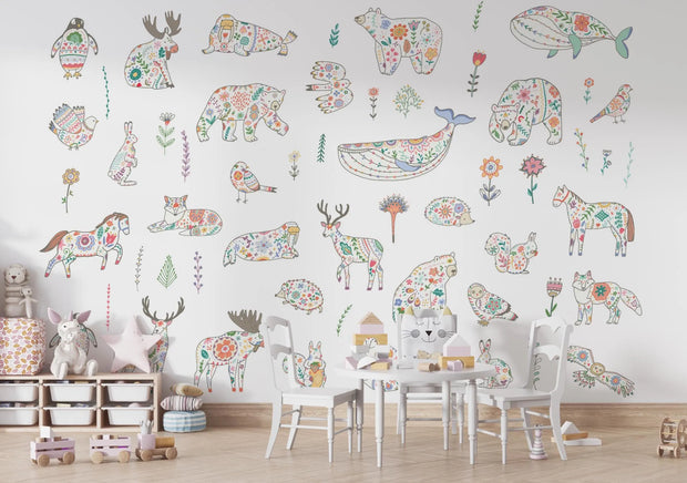Children's room with colorful animal-themed wall decals on a white wall.