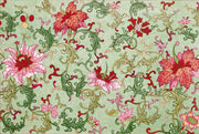Decorative fabric pattern with pink and red flowers on a green background
