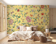 Bedroom with a colorful floral wall mural on a yellow background