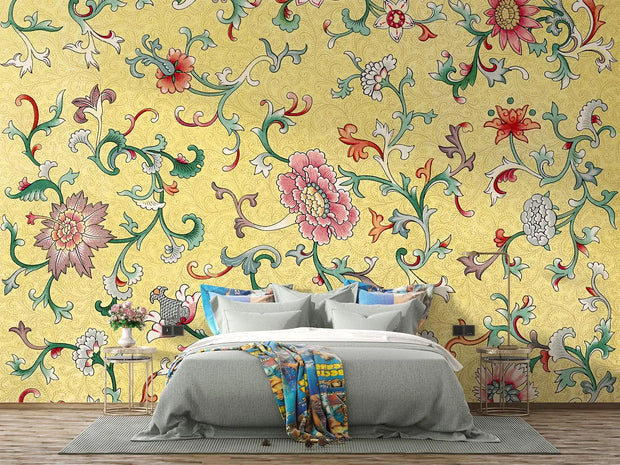 Bedroom with colorful floral wallpaper and a bed with gray bedding.