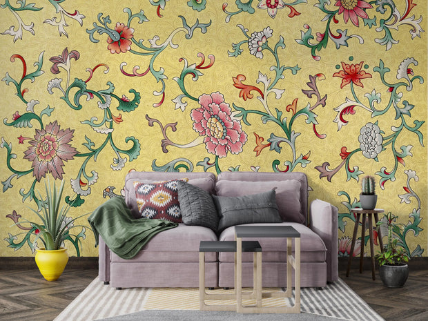 Living room with a gray sofa against a vibrant floral wallpaper.