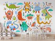 Colorful children's mural of monsters and dinosaurs in a room with furniture.