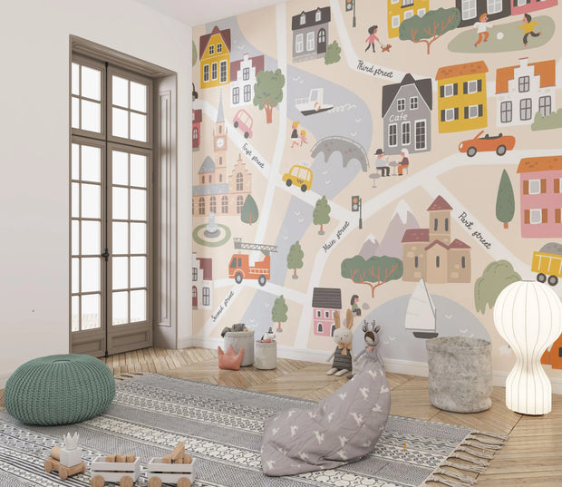 Children's room with colorful wall mural of a town, rug, and toys.