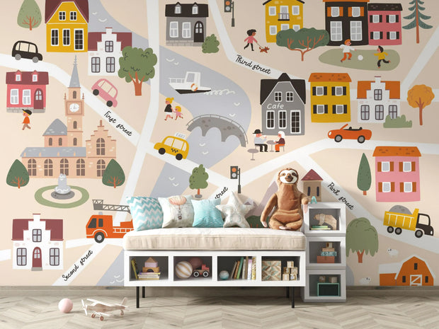 Children's room with a cityscape wall mural featuring houses, roads, and vehicles.