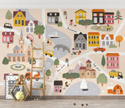 Children's wall mural with a map of a town featuring houses, roads, and vehicles.