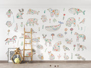 Children's room with floral animal wall decals on a white wall.