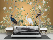 Golden Chinoiserie wall mural with peacocks, egrets, flowering trees and birds