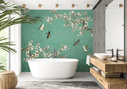 Teal green Chinoiserie wall mural with pink cherry blossoms and birds