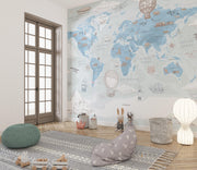 Blue Vintage Travel World Map Wall Mural – playroom with floor cushions mock-up