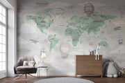 Sage Green Vintage Travel World Map Wall Mural – nursery with an armchair and chest of drawers mock-up