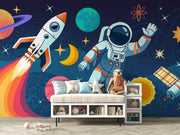 Children's room with space-themed wallpaper featuring an astronaut, rocket, and planets.