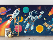 Children's room with space-themed wall mural featuring an astronaut, rocket, and planets.