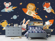 Children's bedroom with space-themed wallpaper featuring animals in rockets and planets.