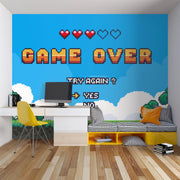 Room interior with pixel art 'Game Over' wall mural, desk, and colorful furniture.