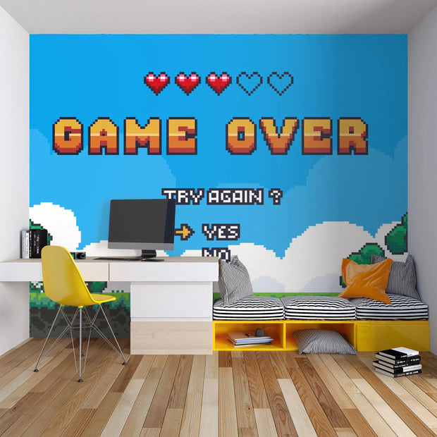 Room interior with pixel art 'Game Over' wall mural, desk, and colorful furniture.