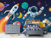 Children's bedroom with space-themed decor, including a rocket and astronaut on the wall.
