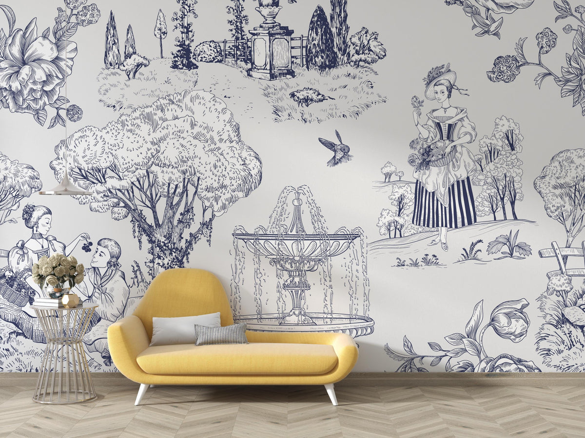 A styled interior scene showing a yellow upholstered lounge chair in front of a wall covered in a blue toile-style mural with floral and architectural illustrations. A small side table with flowers sits to the left, and light wood flooring is visible below.