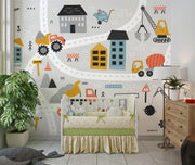 Children's room with crib, wall decals of a cityscape with vehicles, and plants.