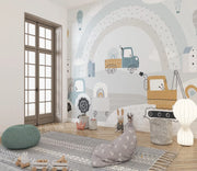 Children's room with a wall mural of vehicles and a green ottoman.