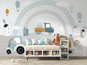 Children's room with toy truck, teddy bear, and colorful wall mural.