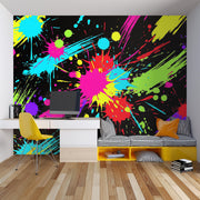 Paint Splatter wall mural with bright neon splashes on black in a modern room
