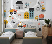 Children's bedroom with a construction-themed wall mural featuring vehicles and buildings.