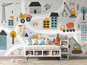Children's room with a cityscape wall mural featuring vehicles and buildings.
