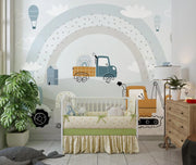 Nursery room with crib, toys, and decorative wall mural of a truck and rainbow.