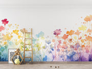 Colorful floral mural on a wall with a wooden ladder and decor items below.