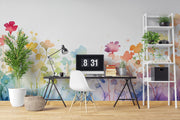 Modern office space with colorful floral wallpaper, desk, chair, and decorative elements.