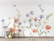 Wall with floral decals and a small ladder against a white wall.