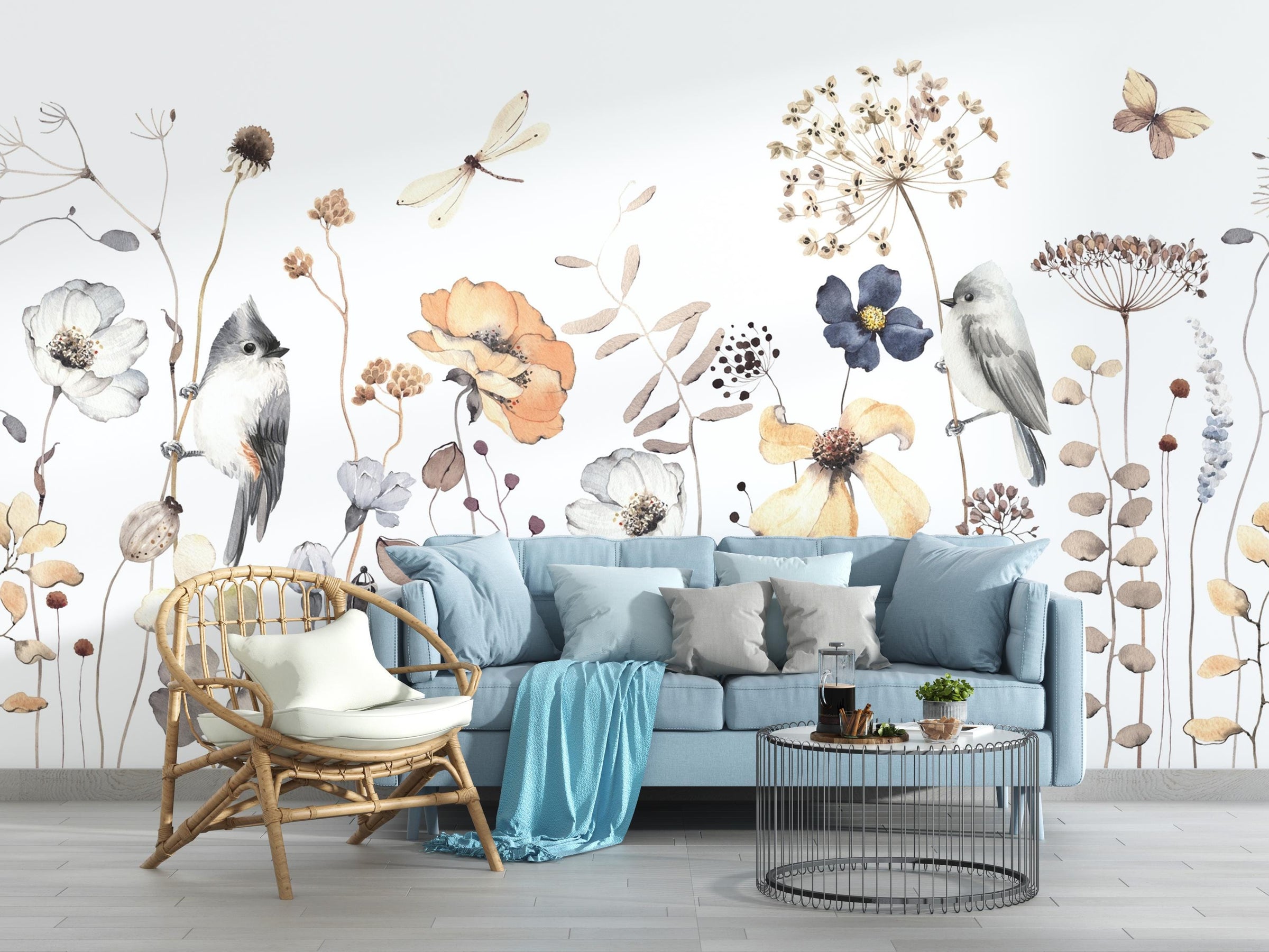 Living room with a blue sofa, wicker chair, and decorative wall mural featuring flowers and birds.