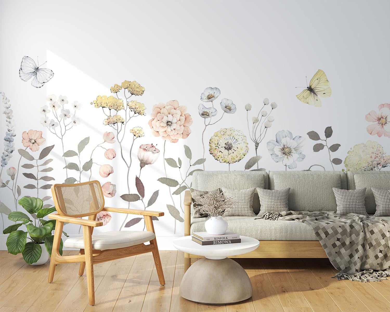 Living room with floral wall decals, a sofa, chair, and coffee table.