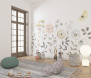 Modern interior with floral wallpaper, pouf, and decorative pillows.