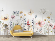 Yellow sofa in front of a wall with floral wallpaper