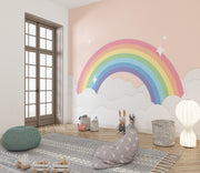Children's room with a rainbow mural on the wall, soft lighting, and decorative items.