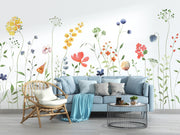 Living room with a blue sofa, wicker chair, and floral wall mural.