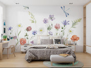 Bedroom with floral wall decals and a neatly made bed.