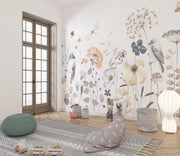 Decorative room with floral wallpaper, pouf, and rug.