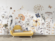 Yellow sofa in front of a wall with floral and bird designs