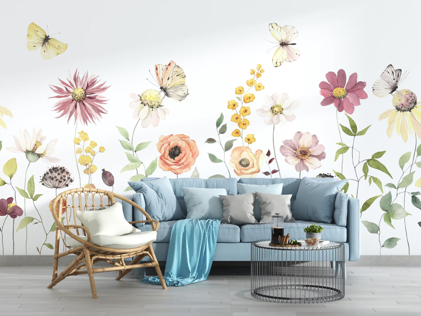 Living room with a light blue sofa, wicker chair, and decorative floral wall mural.